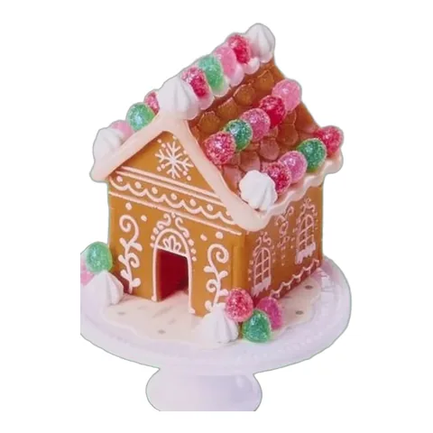 Gingerbread House del calendario de Adviento Miniverse sobre peana blanca con glaseado y gominolas